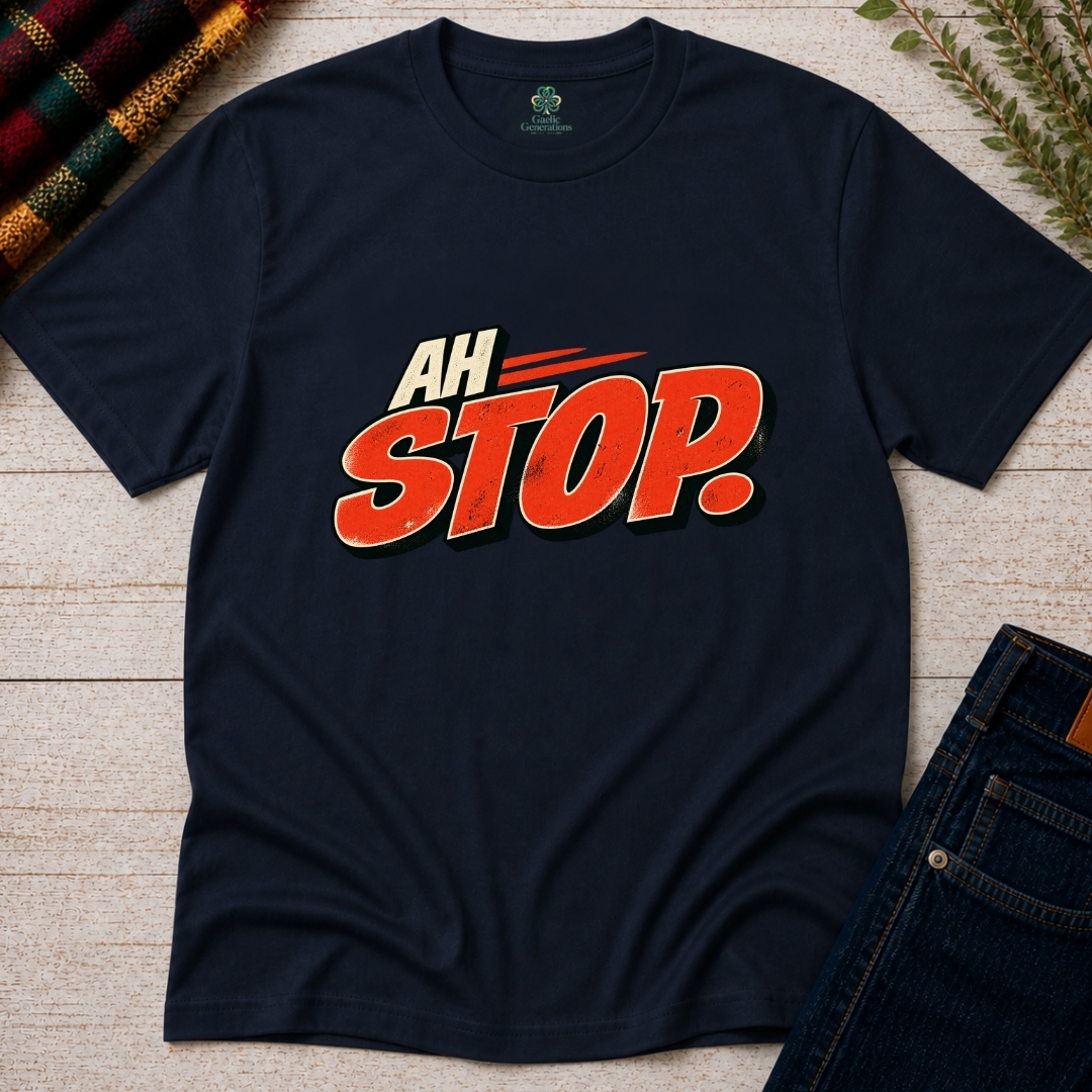 Navy Ah Stop Irish T-shirt displayed flat on rustic wood, featuring bold red-orange vintage lettering with cream outlines