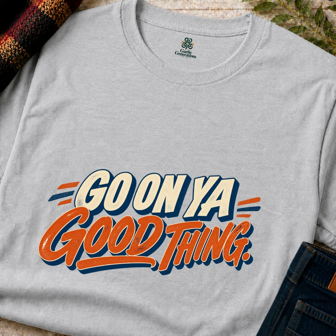 Close-up of ash grey Gaelic Generations Go On Ya Good Thing T-shirt showing distressed orange lettering and cream vintage typography