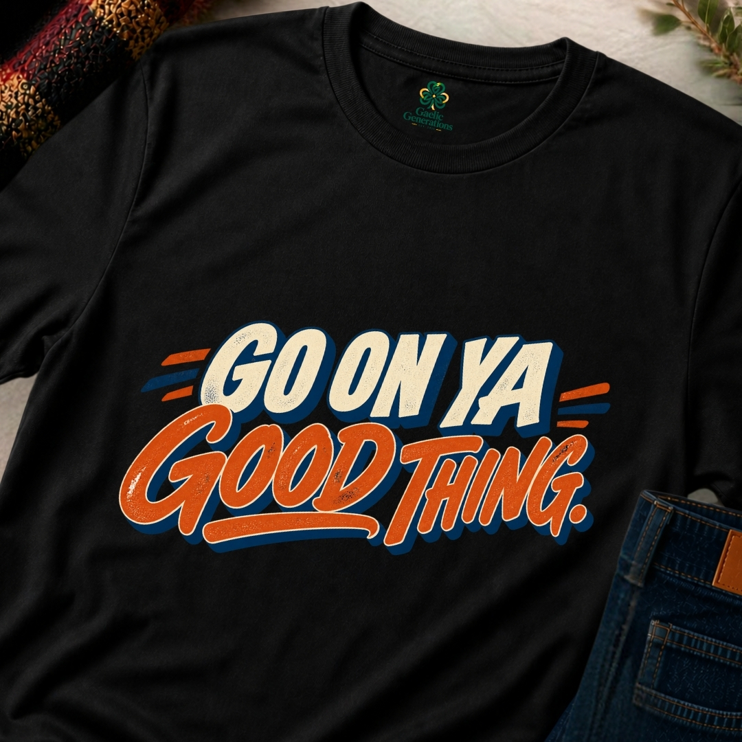 Close-up of black Go On Ya Good Thing Irish slogan T-shirt featuring vibrant orange script, cream lettering and navy shadows