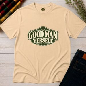 Sand Good Man Yerself Irish T-shirt displayed flat with bold green retro lettering and heritage badge design on rustic wood
