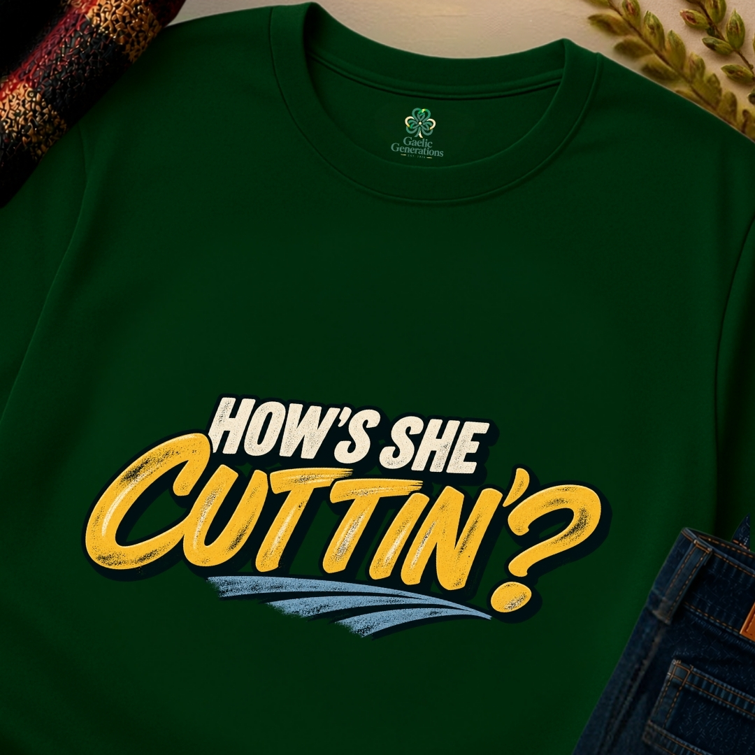 Forest green How's She Cuttin' Irish saying T-shirt shown in close-up with bold golden-yellow typography and distressed blue underline