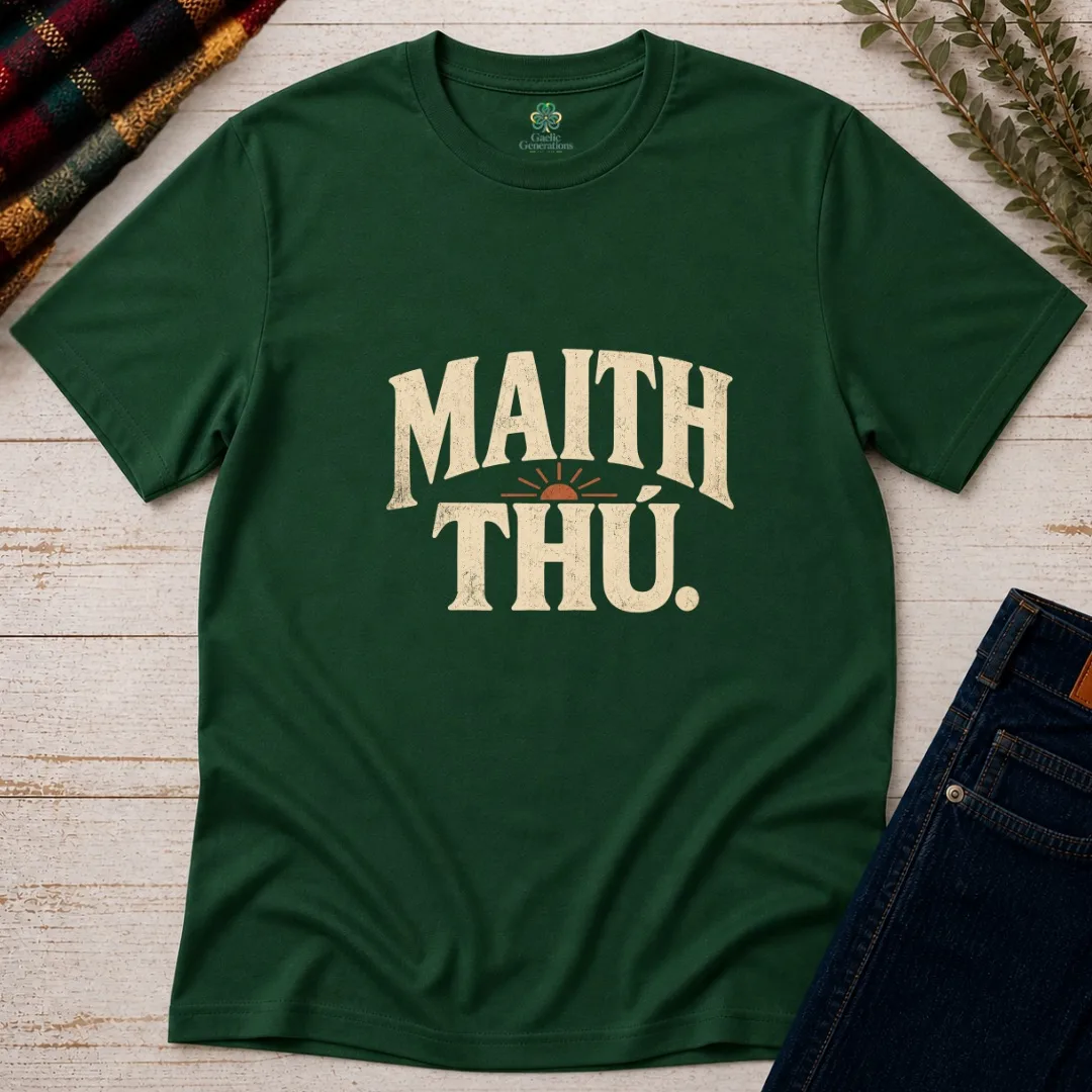 Forest green Maith Thú Irish language T-shirt with vintage cream lettering and rust sunrise graphic