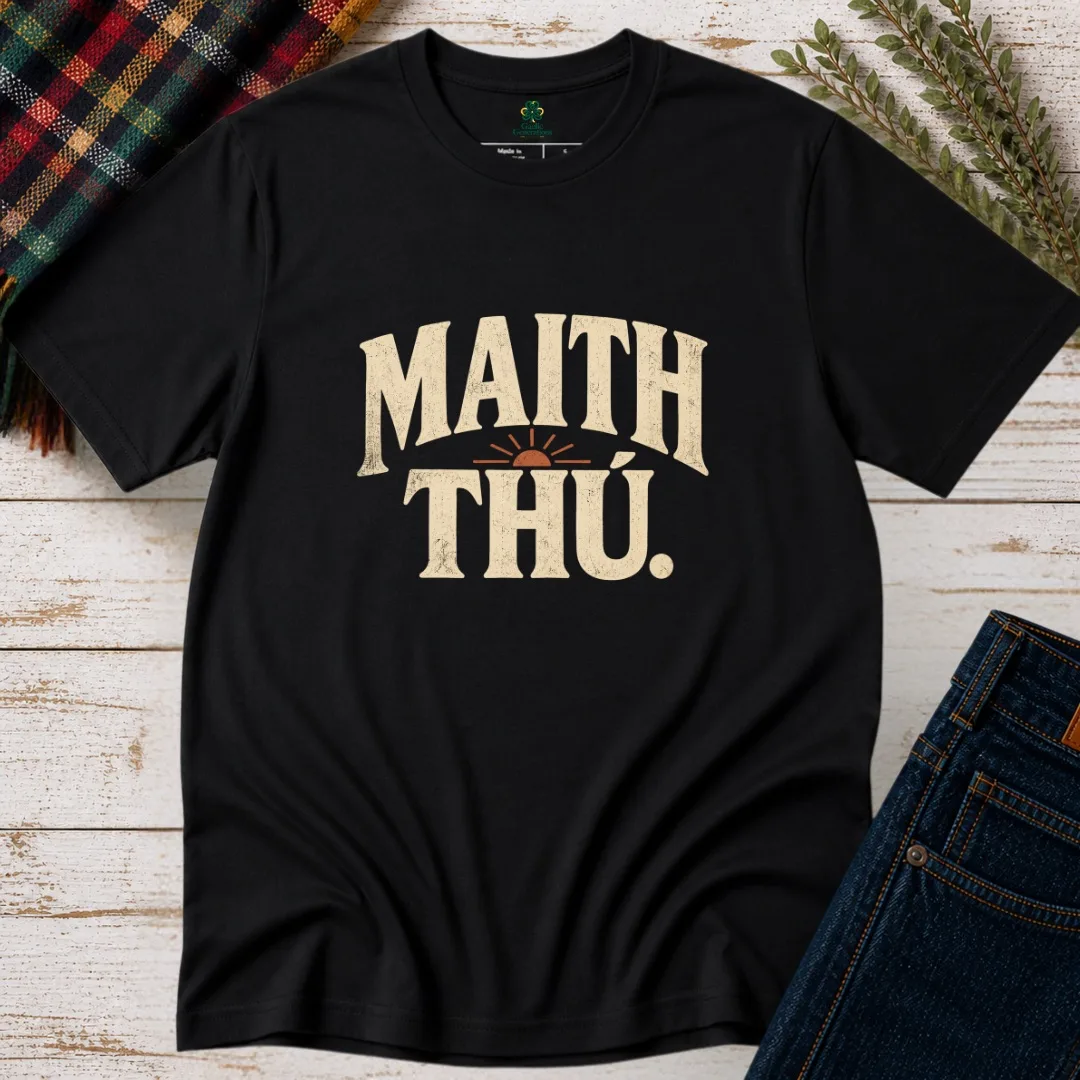 Black Maith Thú Irish language T-shirt with cream vintage lettering and rust sunrise graphic