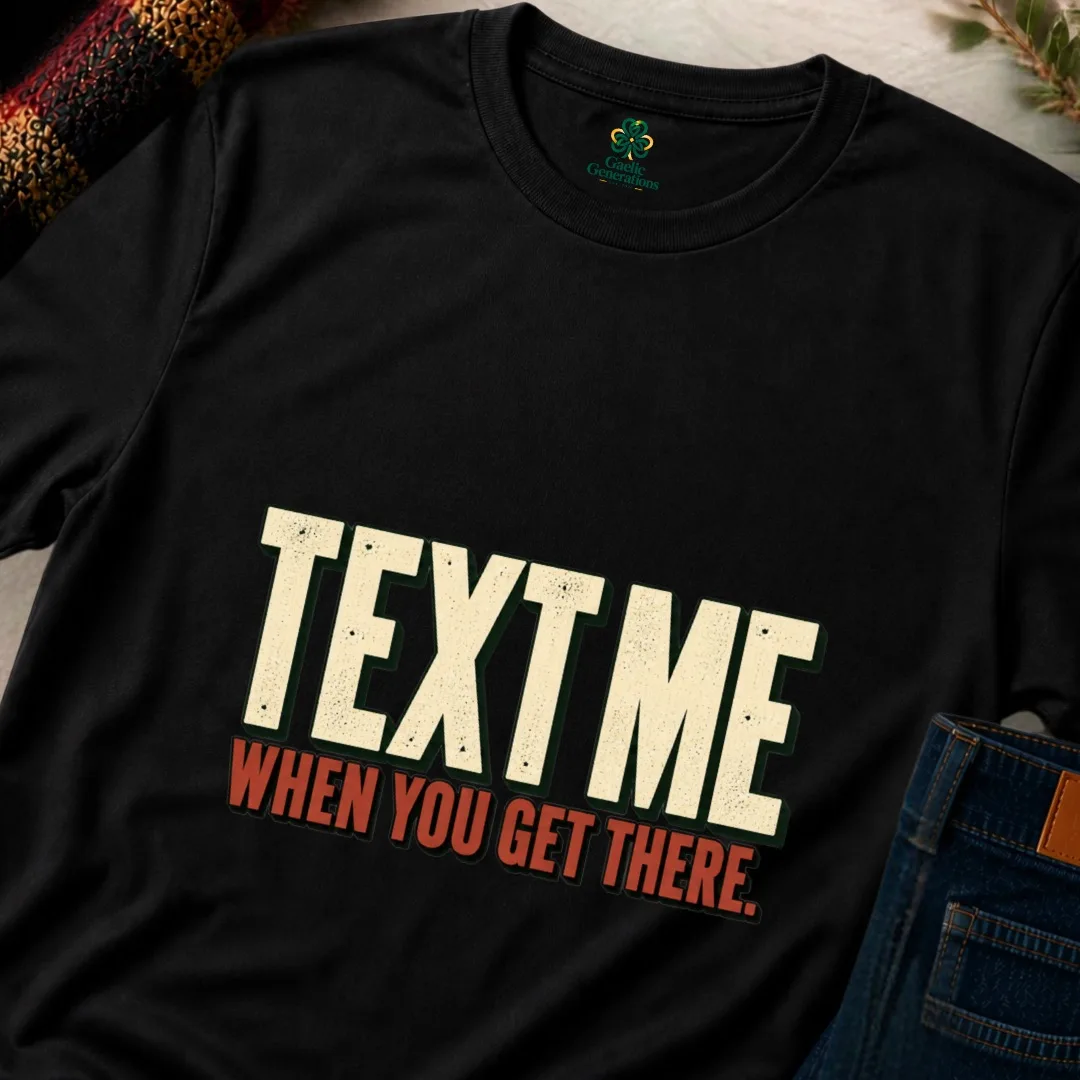 Close-up of black Text Me When You Get There T-shirt showing distressed cream and rust typography