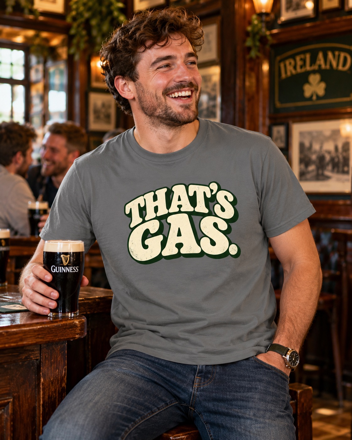 Man wearing a black That's Gas T-shirt while drinking Guinness in a bar