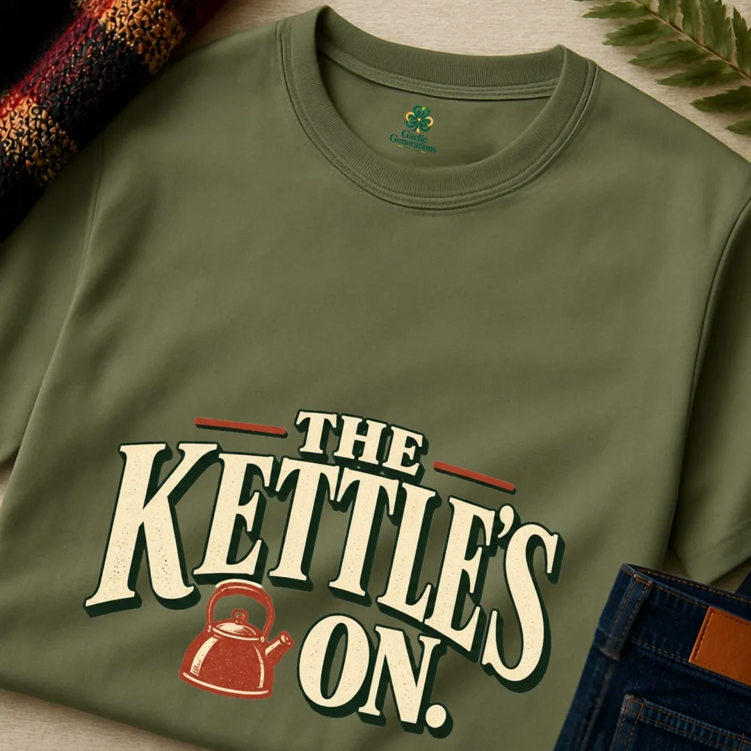 Close-up of military green The Kettle’s On T-shirt with cream lettering and rust vintage kettle illustration
