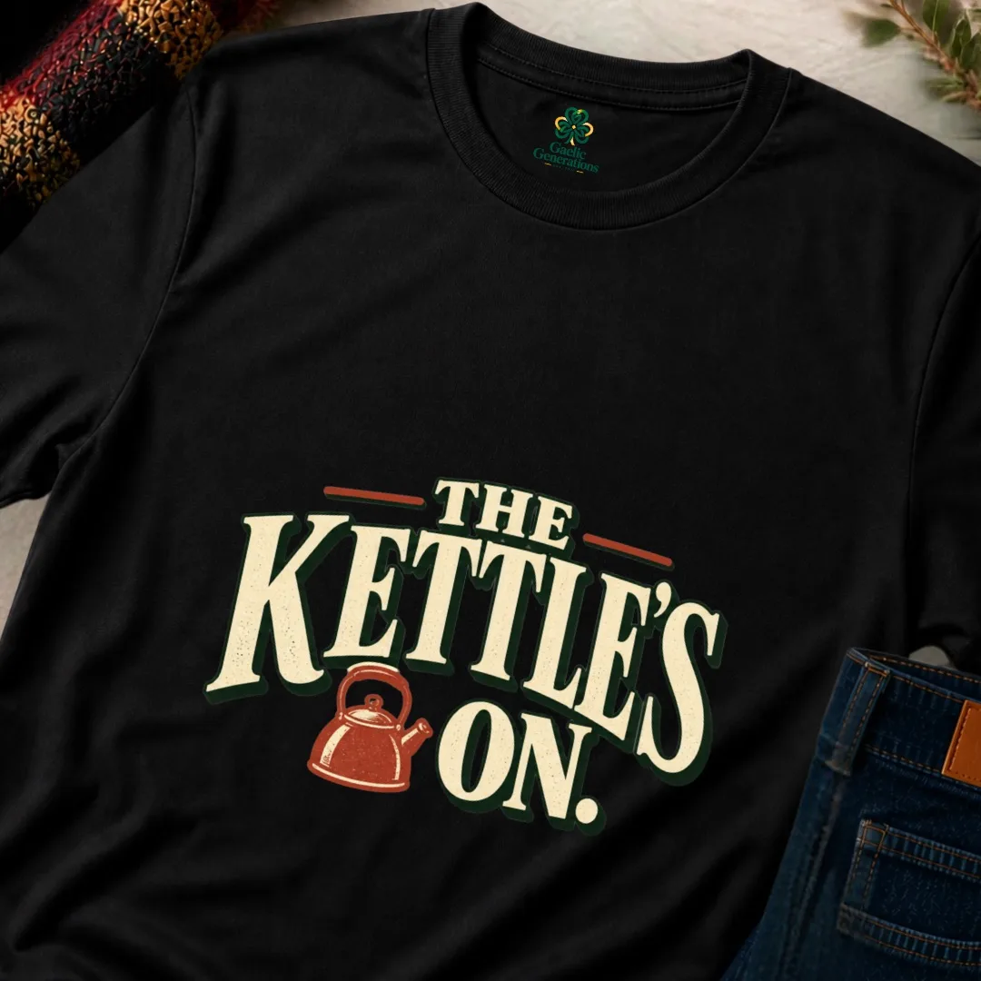 Close-up of black The Kettle’s On T-shirt showing cream vintage typography and rust kettle design